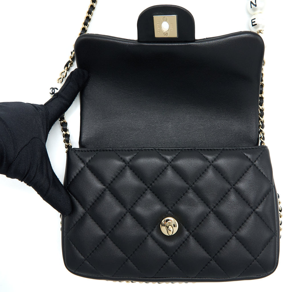 CHANEL SMALL PEARL LOGO STRAP FLAP BAG LAMBSKIN BLACK LGHW